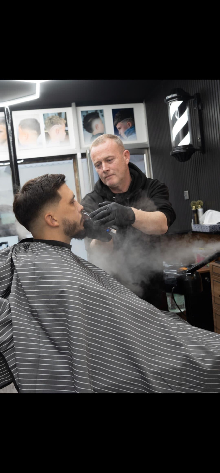 Barber finishing a client's beard at Rich The Barber in Barry